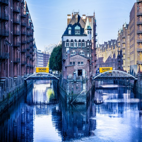 DACHSER trucks crossing bridges in an urban environment