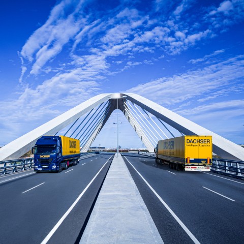 DACHSER trucks crossing a cable-stayed bridge for road freight transport
