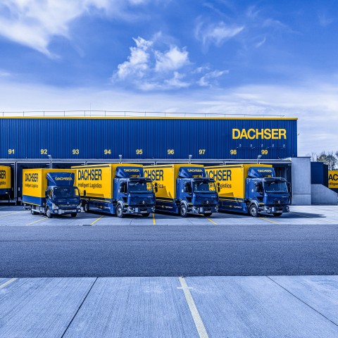 DACHSER trucks at loading docks of a logistics facility