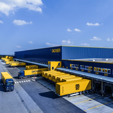 DACHSER logistics center with trucks at loading docks